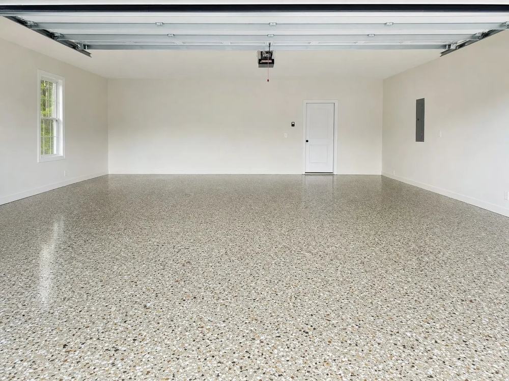 Bright garage with a glossy Creekbed flake epoxy floor