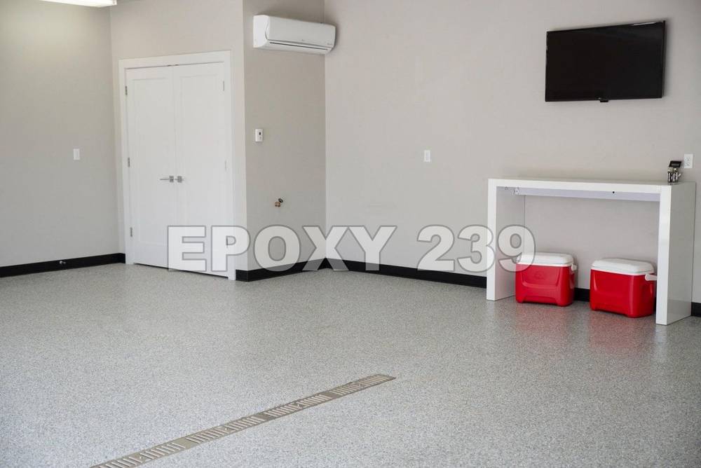 Bright bonus room with a light grey flake epoxy floor