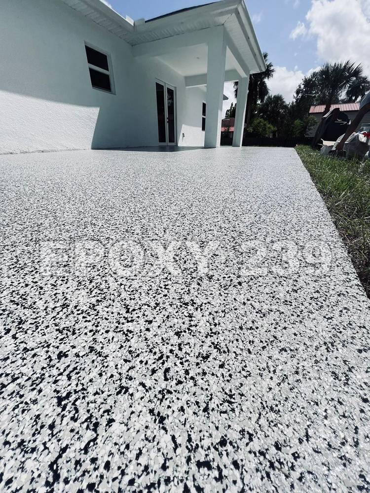 Outdoor walkway beside a house in black and white flake epoxy